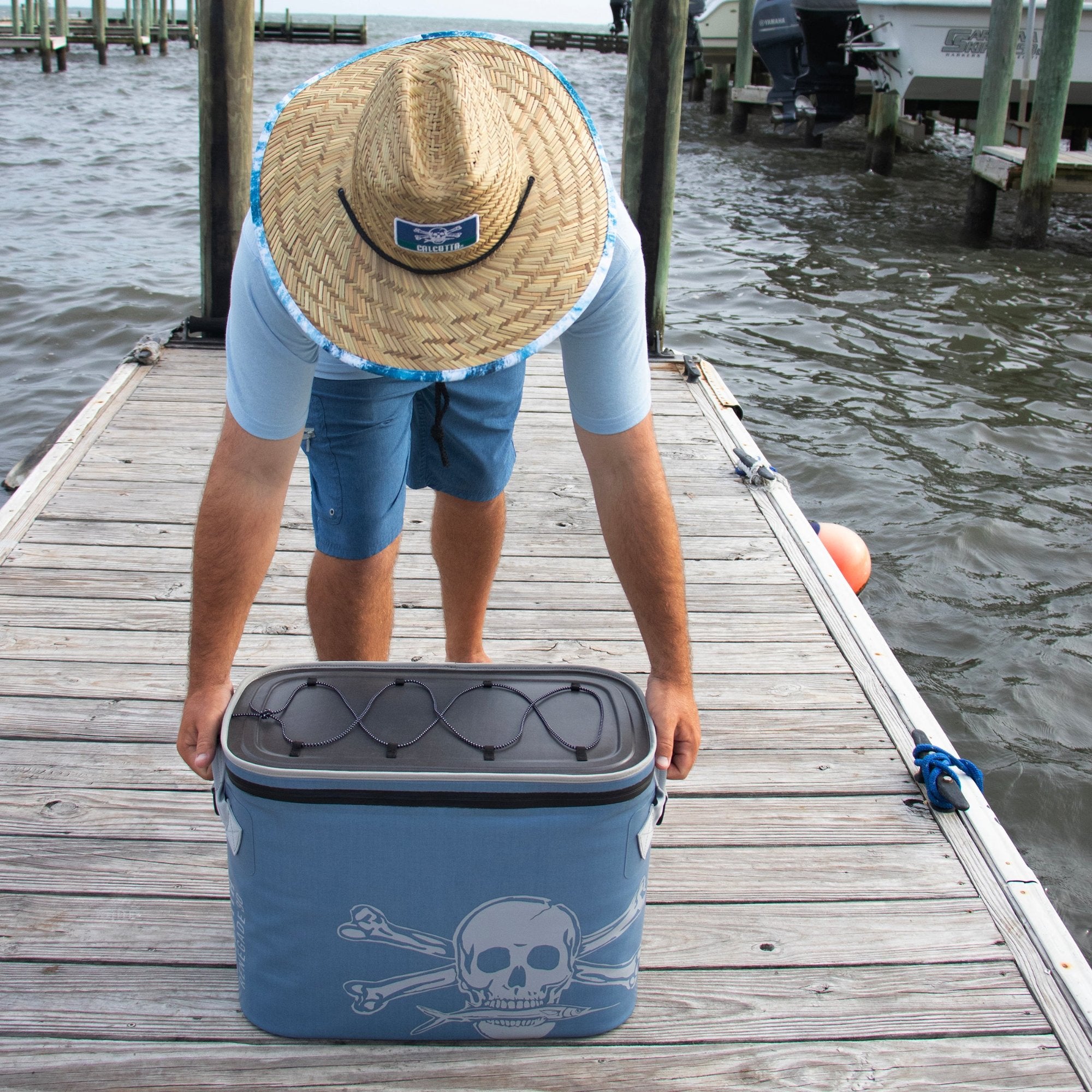 Man picking up Renegade soft cooler 30 liter