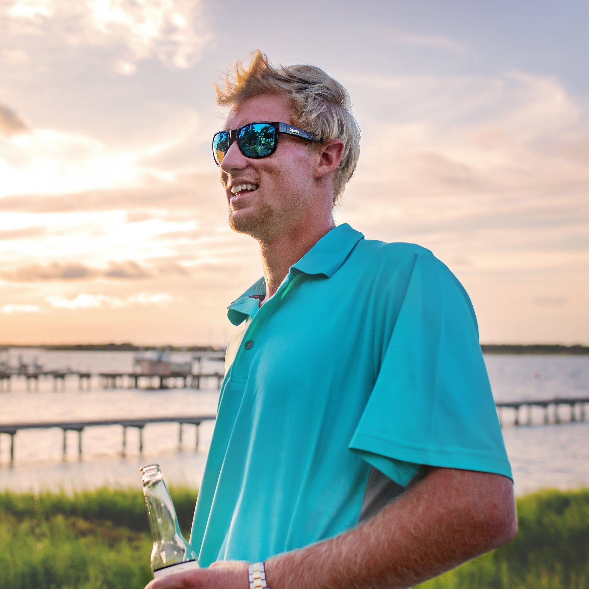 Man wearing Calcutta blue polo performance shirt