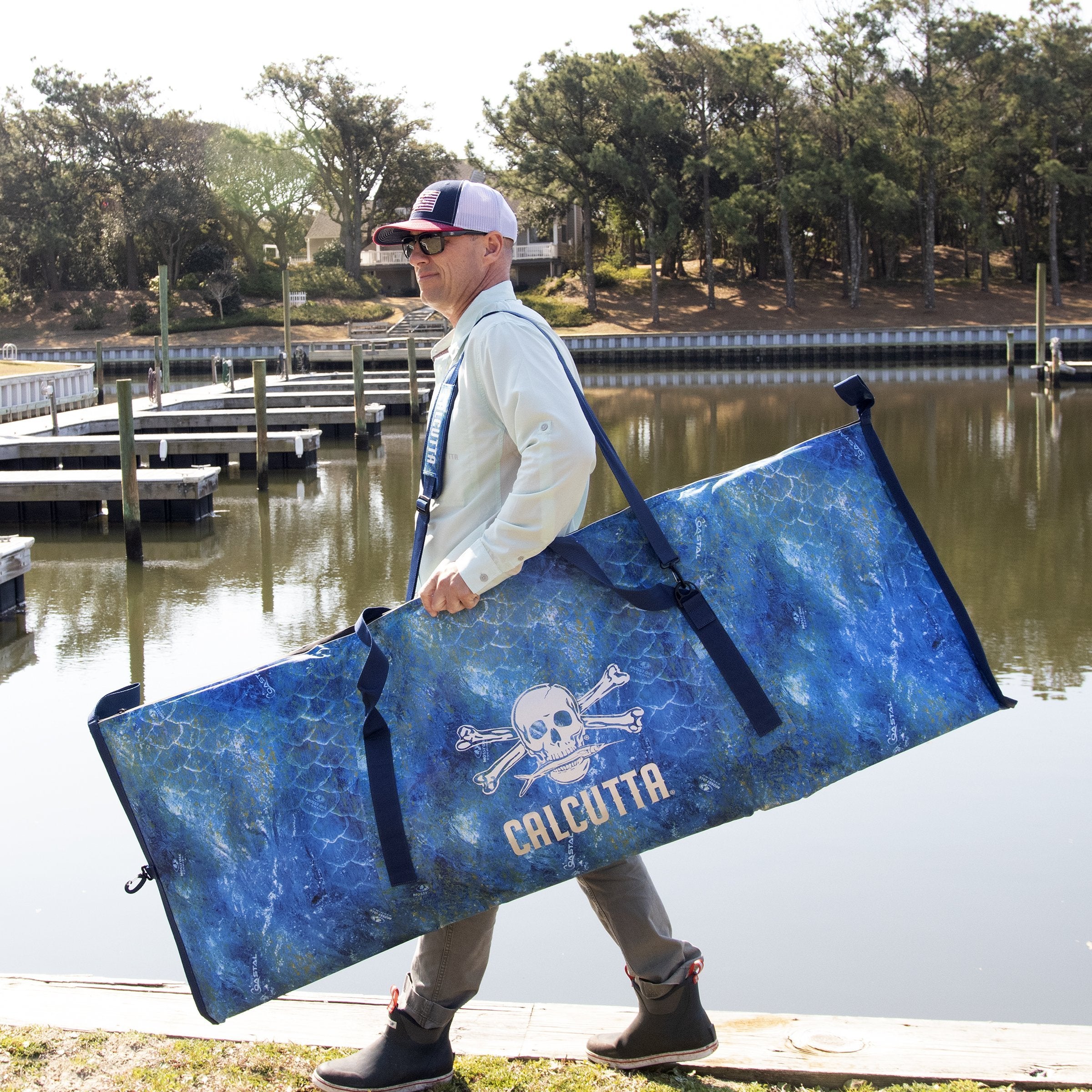 Fish cooler kill bag in Mossy Oak Coastal Shoreline pattern on shoulder oof fisherman
