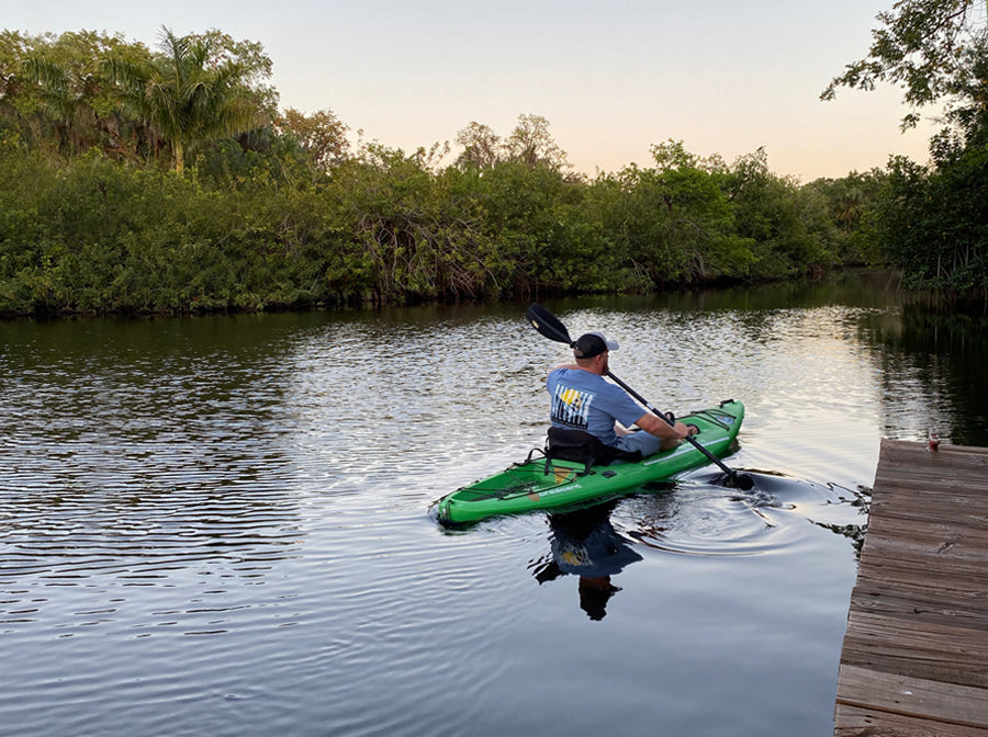 Man paddling kayak in canal