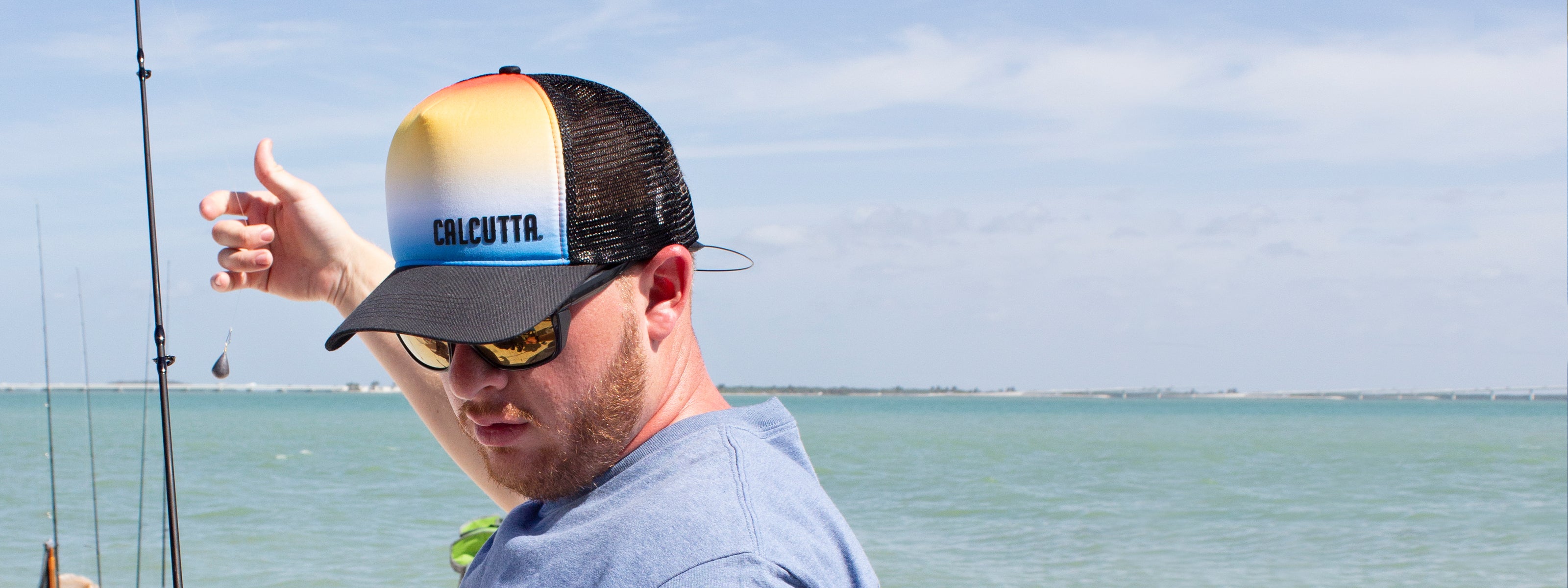 Man on beach wearing Calcutta hat