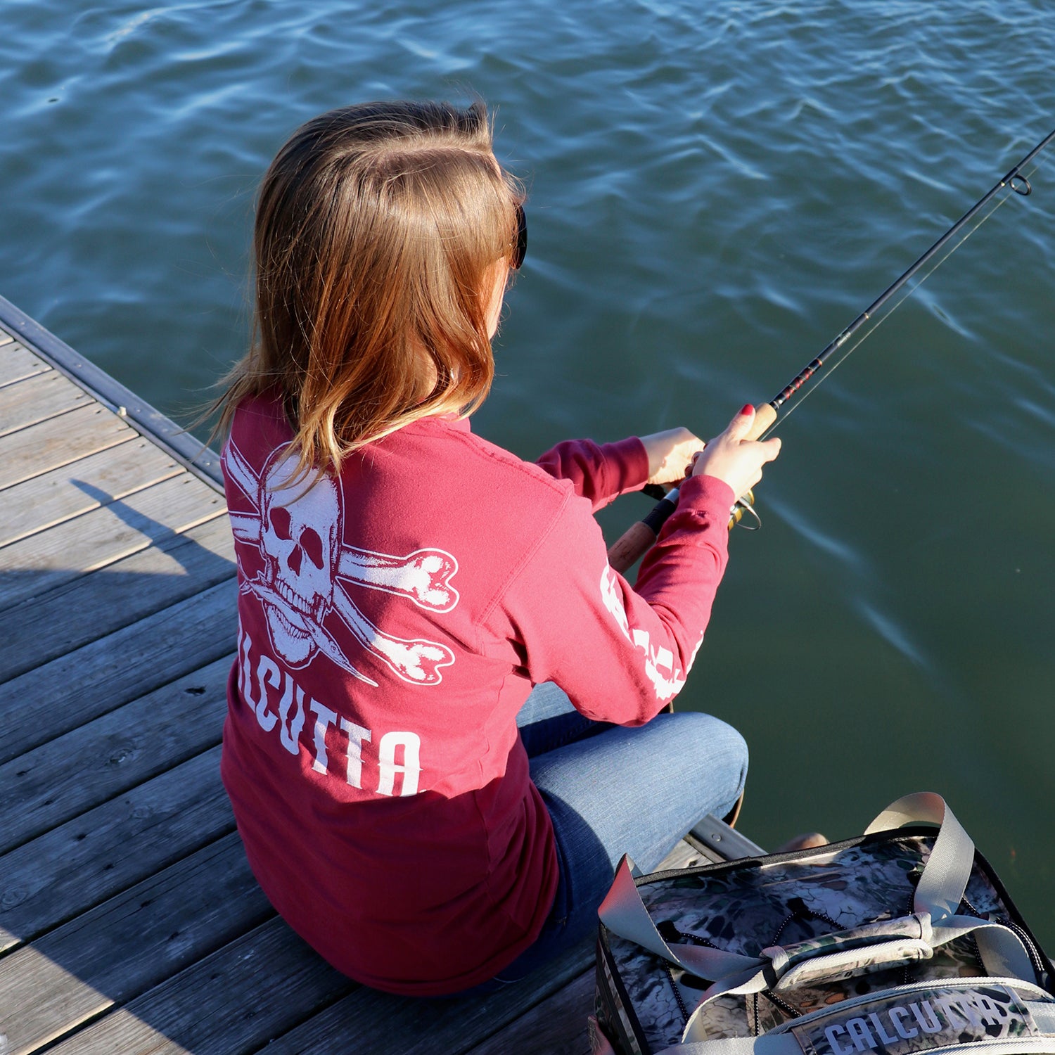 Female angler fishing off dock in Calcutta long sleeve shirt