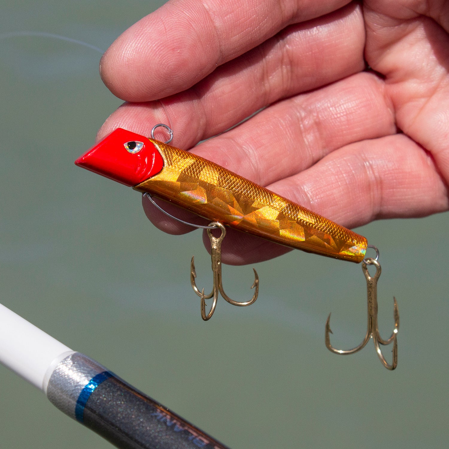 Got-cha Pro fishing lure with gold body and red head